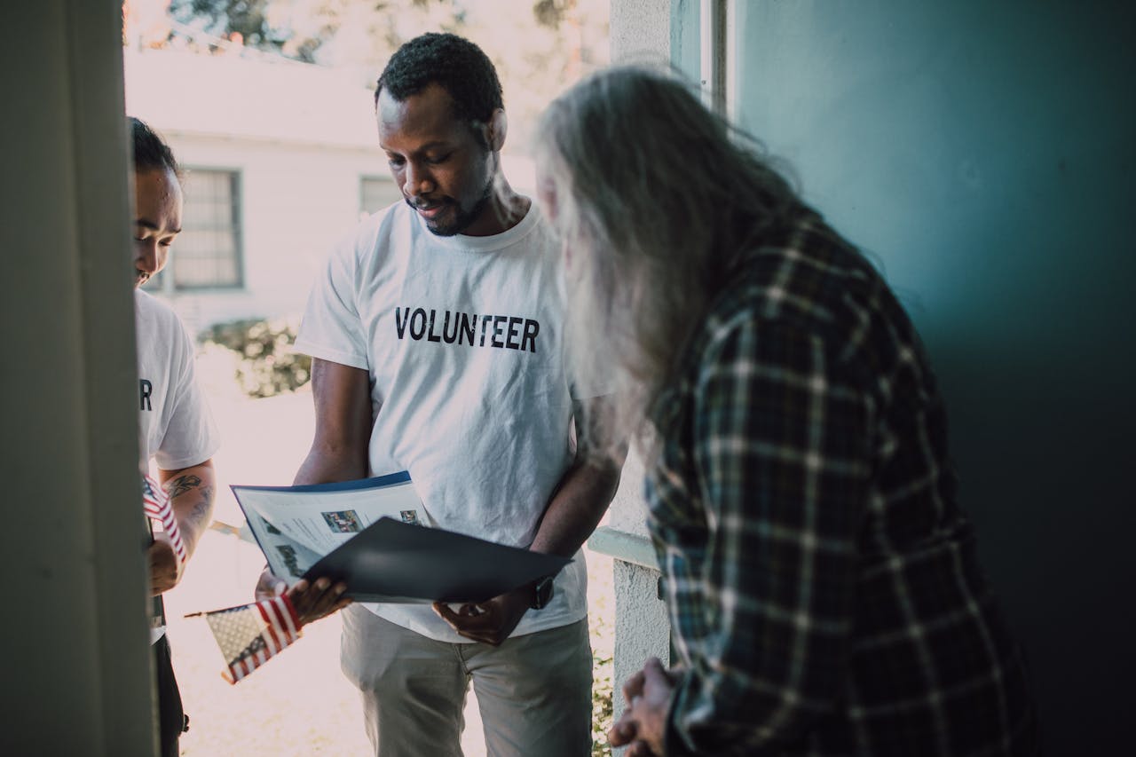 Volunteers visit a home to provide community support and discuss documents.